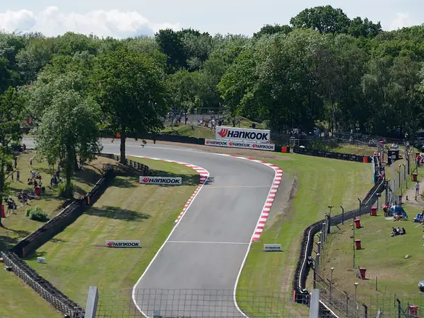 Track curving downhill through trees at Sheene Curve, Brands Hatch