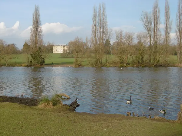Lake in Danson Park with Danson House in the distance beyond the trees