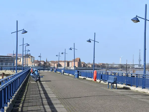 Lamp posts and blue railings along the deck of Erith Pier over the Thames