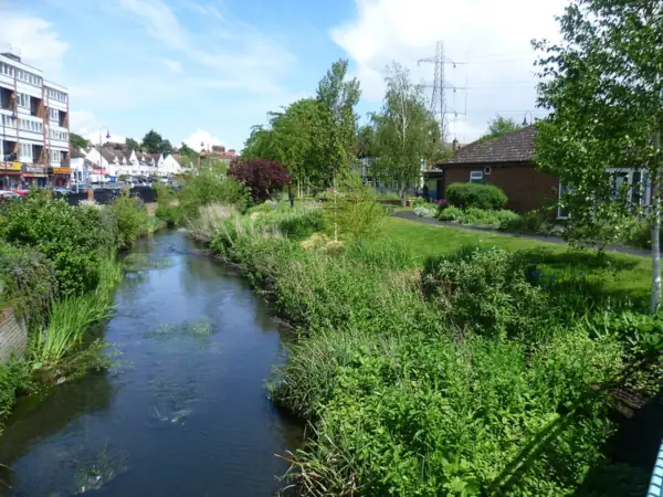 River Cray running between planted banks in Waterside Gardens, Crayford town centre
