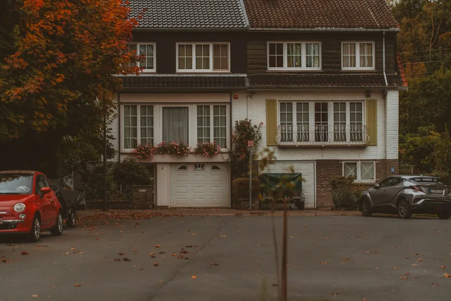 Pair of 1960s semi-detached houses with integral garages and tiled roofs, typical of the postwar estates being re-roofed around Dartford