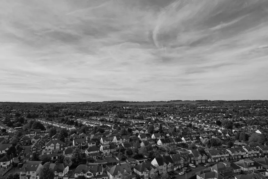 Black and white aerial view over streets of 1930s semi-detached houses and their roofs, the housing type behind most Dartford re-roofing jobs