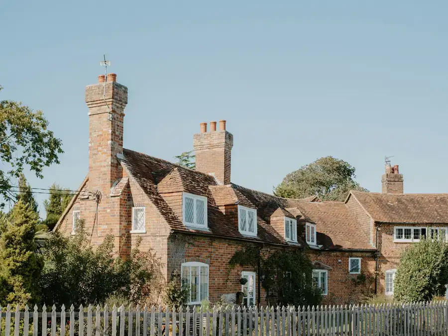 Brick houses with steep clay tiled roofs, small dormers and tall chimney stacks, similar to the hipped interwar roofs found around Wilmington