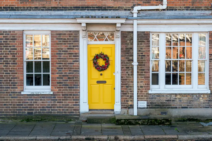 Front door of a brick terraced house, the kind of doorstep where cold-calling roofers in Dartford and Kent turn up