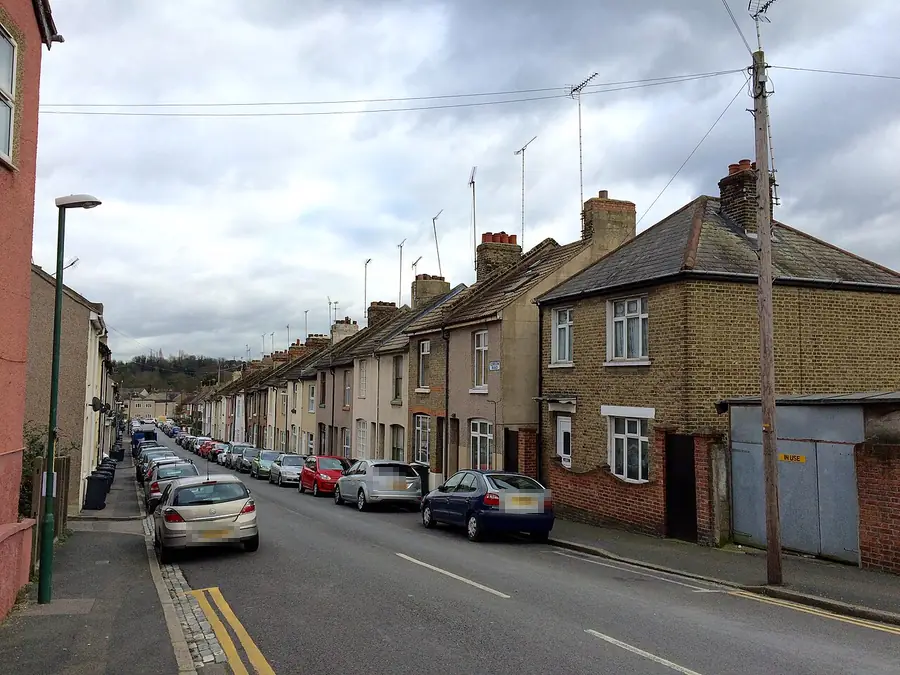 Long run of terraced houses with chimneys stepping down Gordon Road, Dartford