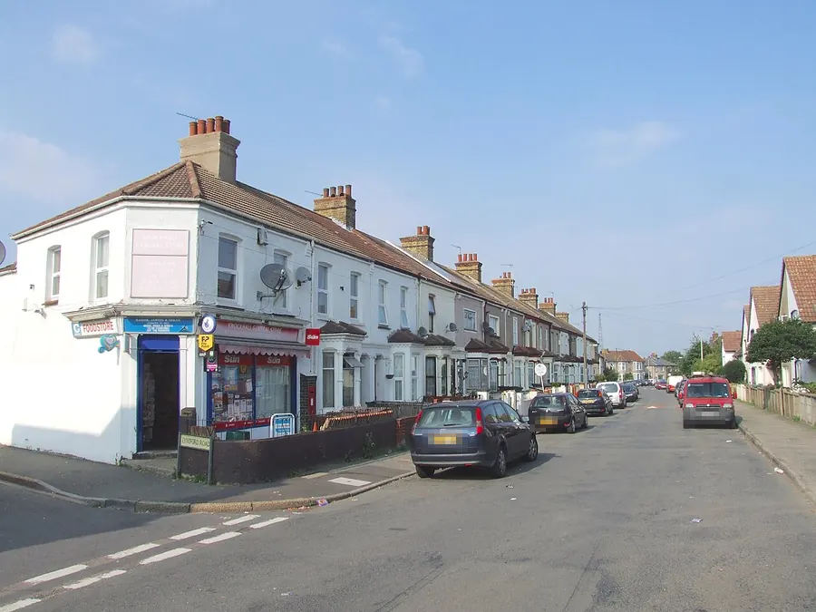 Long Victorian terrace with bay windows and chimneys on Knockhall Road, Greenhithe