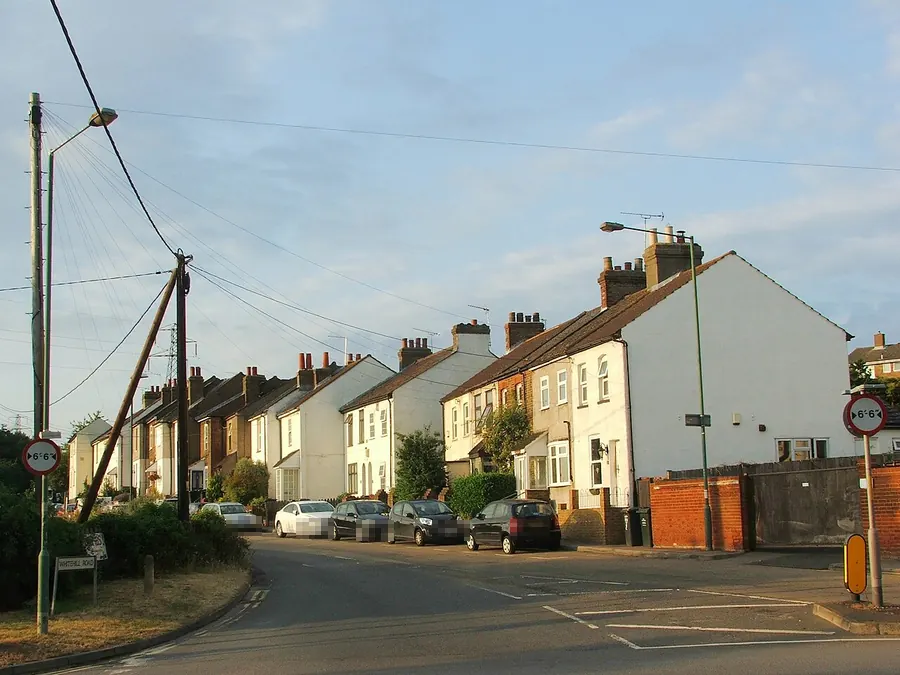Row of older terraced and semi-detached houses with chimneys on Whitehill Road, Longfield