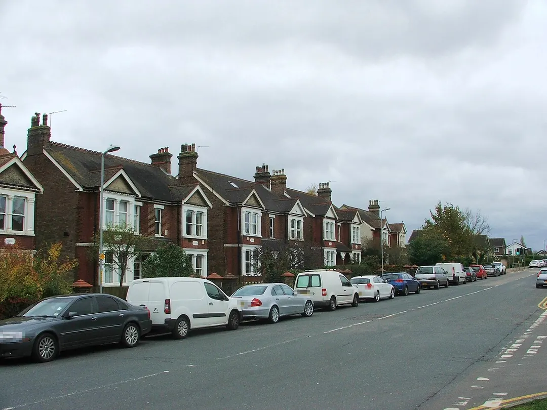 Edwardian red-brick semis with gables and chimney stacks along Goldsel Road, Swanley