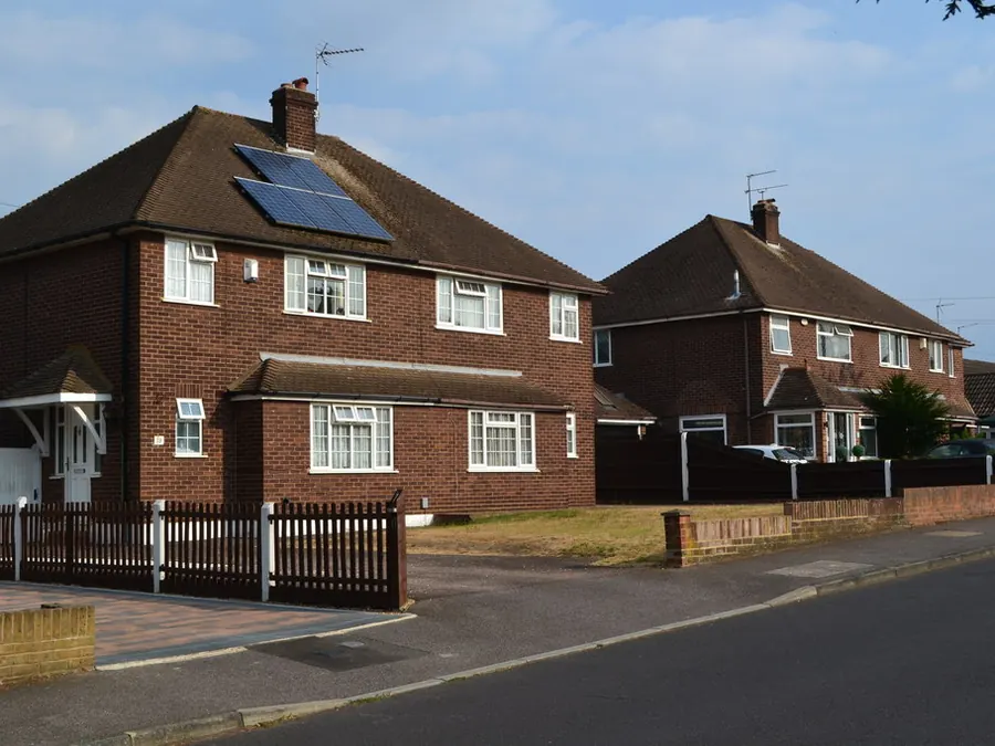 Brick semi-detached houses with hipped tiled roofs and solar panels on Wilmington Court Road, Wilmington