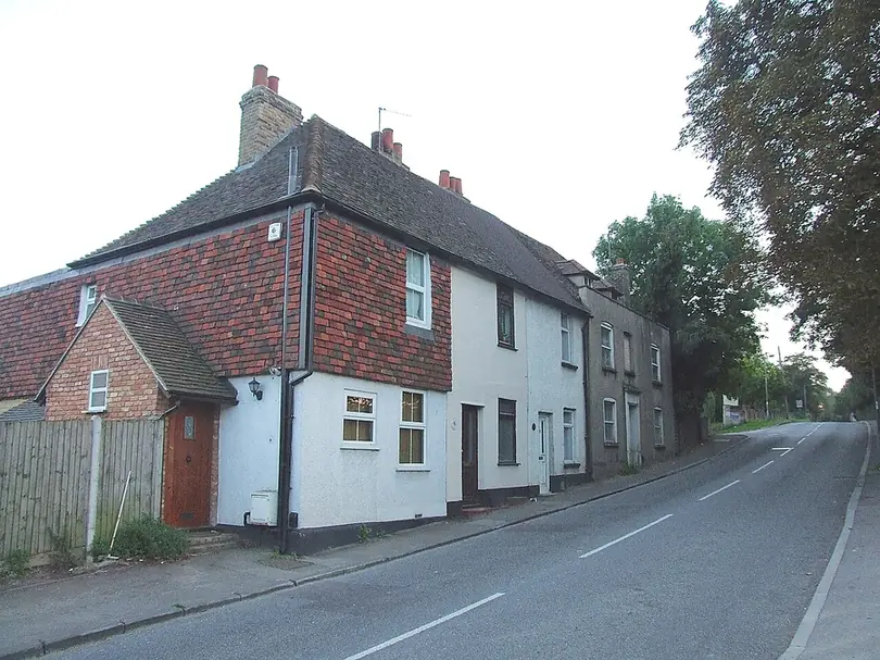 Old tile-hung cottage with white-rendered neighbours and a clay-tiled roof on Church Hill, Wilmington